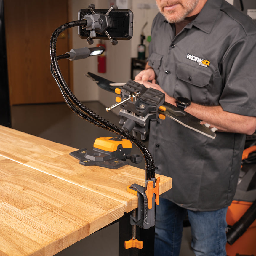 A person working on a project on a workbench while using the IQ Vise System.