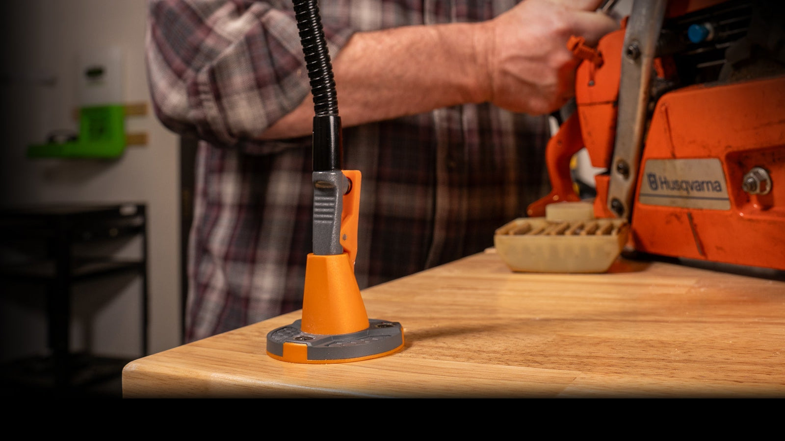 A person using a WorkIQ clamp to hold a workpiece on a workbench.